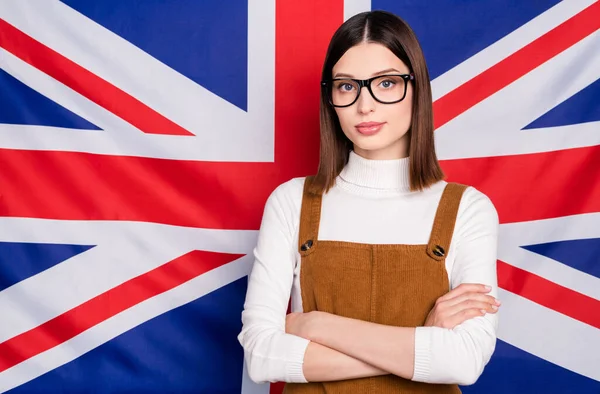 Foto de una joven confiada estudia en el extranjero en el programa de conocimiento internacional aislado bandera británica fondo —  Fotos de Stock