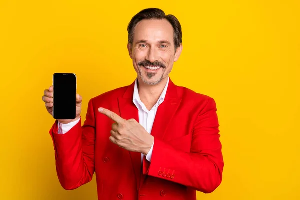 Sarı arka planda izole edilmiş şık, lüks giyinmiş, akıllı telefon reklamı yapan bir adamın fotoğrafı. — Stok fotoğraf