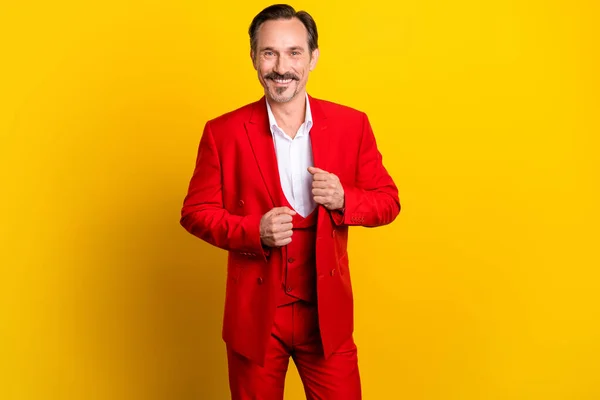 Photo d'homme d'affaires attrayant bien habillé en costume rouge vif se préparer pour la fête isolé sur fond de couleur jaune — Photo
