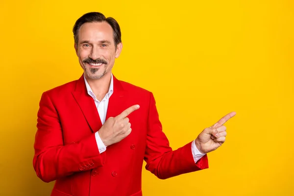 Photo of cheerful mature man indicate fingers epmty space promo advert choice isolated over yellow color background — Stock Photo, Image