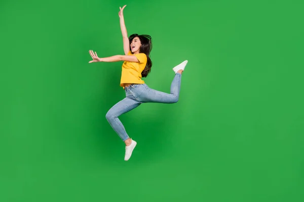 Volledige lengte foto van aantrekkelijke jonge vrouw springen omhoog kijken lege ruimte dans ballerina geïsoleerd op groene kleur achtergrond — Stockfoto