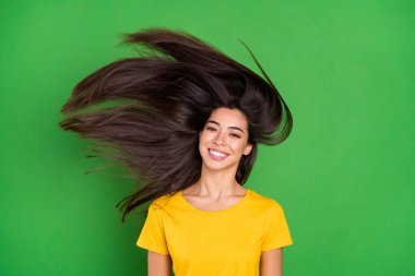 Photo of positive young charming woman fly hair hairstyle smile good mood isolated on green color background clipart