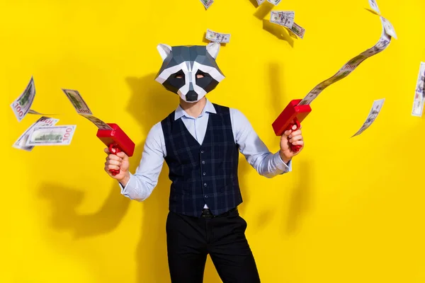 Photo of charismatic authentic guy racoon mask shoot pistol profit money sale trendy party look isolated over yellow color background — Stock Photo, Image