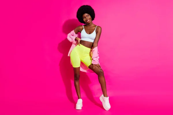 Photo of sweet charming dark skin lady wear casual shirt looking empty space smiling isolated pink color background — Stock Photo, Image