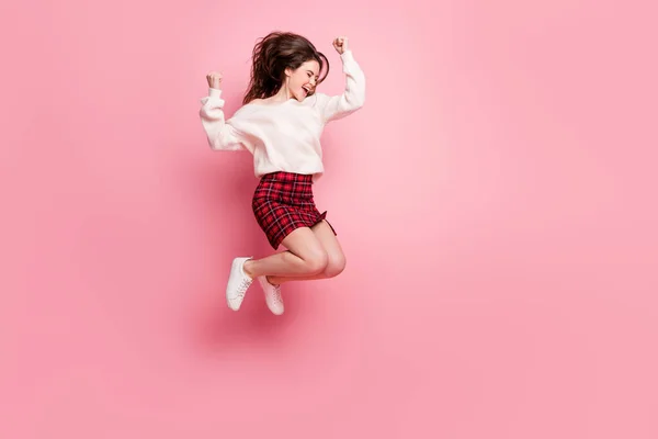 In voller Länge Profil Seite Foto von jungen aufgeregten Mädchen glücklich Lächeln springen freuen Sieg Fäuste Hände isoliert über rosa Farbhintergrund — Stockfoto