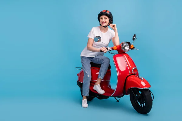 stock image Portrait of attractive dreamy cheerful dreamy woman sitting on moped thinking isolated over bright blue color background