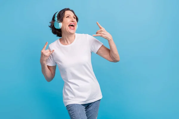 Portrait of atraktif trendy cheerful woman listening hit singing shows horn sign isolated over bright blue color background — Stok Foto