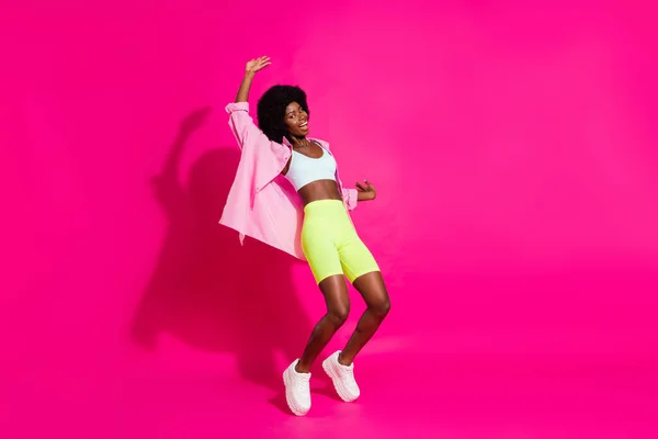 Photo of pretty adorable dark skin woman dressed crop top smiling dancing isolated pink color background — Stock Photo, Image