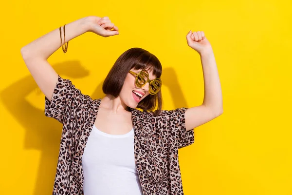 Photo of cool young hipster lady dance wear eyewear bracelet leopard shirt isolated on yellow color background — Foto Stock