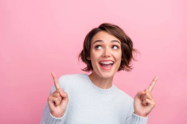 Photo of funny surprised lady direct fingers empty space wear blue sweater isolated pink color background — Stock Photo, Image