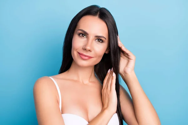 Photo of gorgeous satisfied girl arms touch hair enjoy freshness look camera isolated on blue color background — Stockfoto