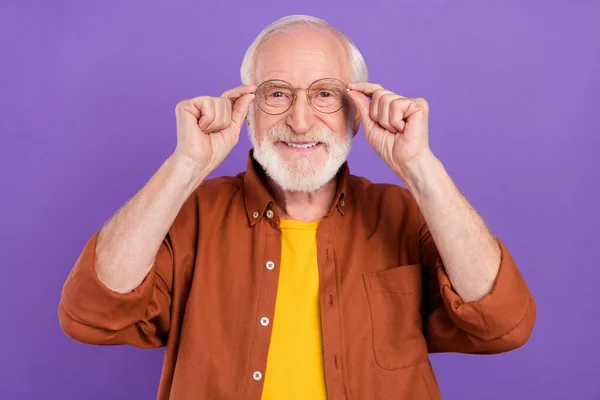 Photo of optimistic old man hands glasses wearing brown shirt isolated over purple color background — Stock Photo, Image