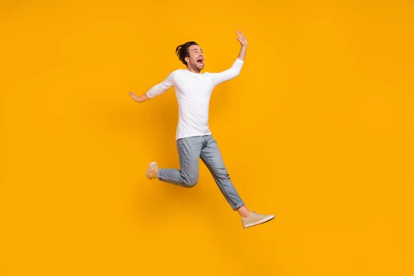 Full length photo of stressed brunet millennial guy run wear shirt jeans shoes isolated on yellow background — Stockfoto