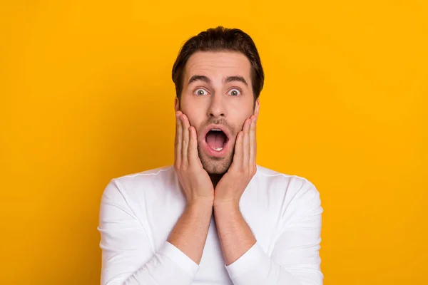 Photo of millennial impressed brunet guy open mouth wear white shirt isolated on bright yellow color background — Stockfoto