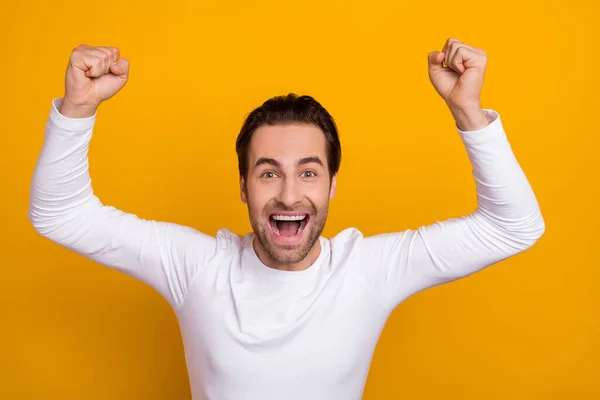 Photo of overjoyed delighted guy raise fists lucky scream hooray yes isolated on yellow color background — 图库照片