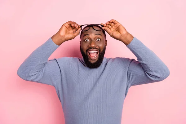 Photo of positive surprised guy open mouth take off eyewear open mouth wear grey shirt isolated pink color background — Stockfoto