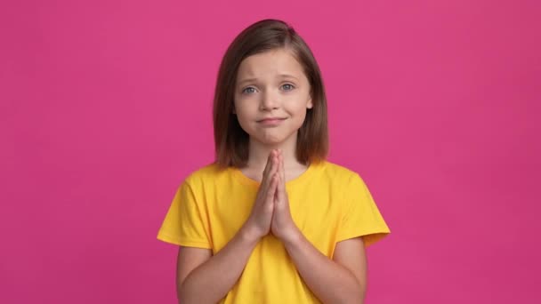 Sad schoolkid praying gesture want gift isolated shine color background — Stockvideo