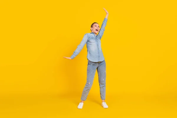 Full length body size photo cheerful careless girl laughing dancing at party isolated bright yellow color background — ストック写真