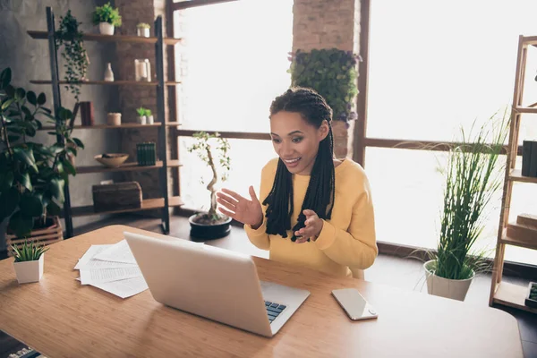 Photo of sweet friendly dark skin lady wear yellow sweater having video call modern device smiling indoors house room — Stockfoto