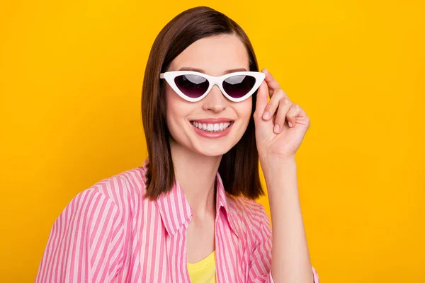 Portrait of satisfied candid person arm touch sunglass toothy smile isolated on bright yellow color background — 图库照片