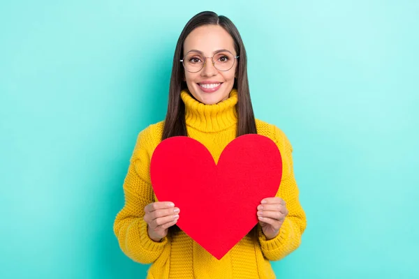 Photo of cute adorable lady dressed yellow pullover glasses holding big red heart isolated teal color background — Foto Stock