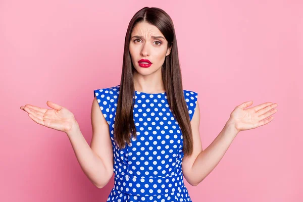 Portrait of attractive puzzled glamorous long-haired girl shrugging shoulders isolated over pink pastel color background — 图库照片