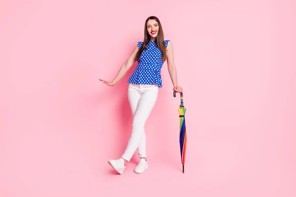 Full length body size view of attractive cheerful girl holding parasol walking posing good mood isolated over pink pastel color background — 图库照片