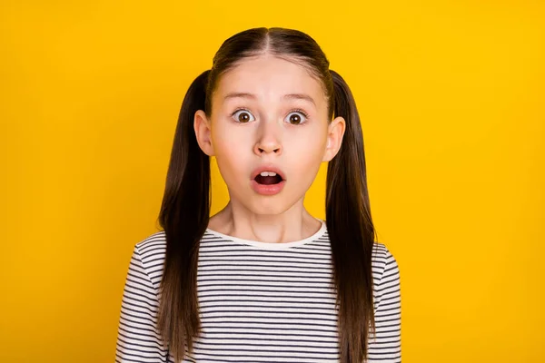 Photo of young school girl amazed surprised afraid scared fail mistake isolated over yellow color background — 图库照片