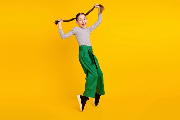 Full body profile side photo of young excited girl happy positive smile fooling isolated over yellow color background — 图库照片