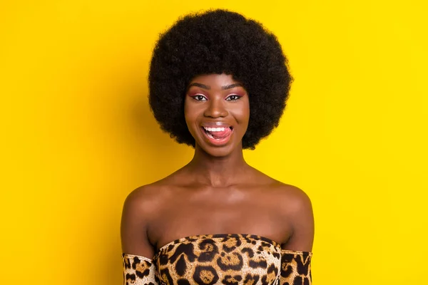 Photo of cute flirty dark skin woman dressed leopard outfit licking lips smiling isolated yellow color background