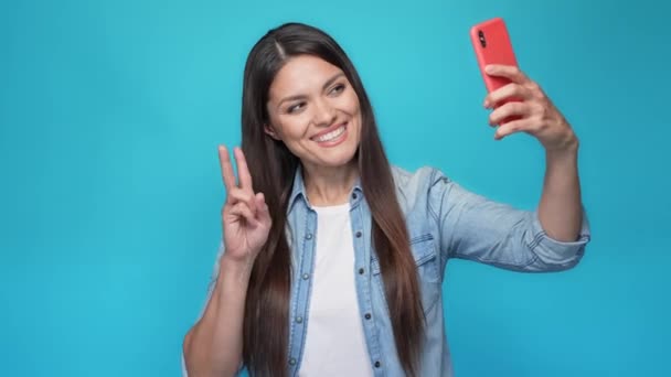 Lady make selfie gadget v-sign thumb up fine isolated blue color background — Video Stock