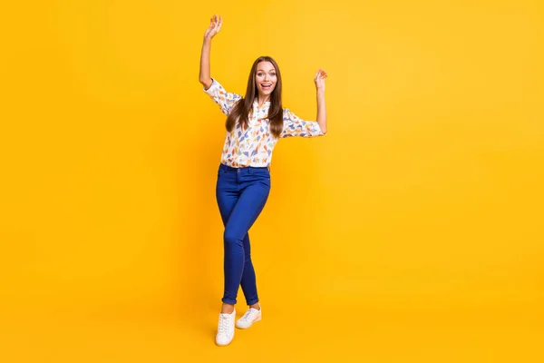 Full length photo portrait of excited girl dancing isolated on vivid yellow colored background — 图库照片