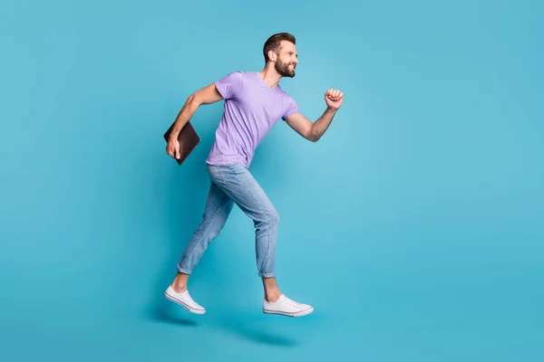Full length body size photo of jumping student with computer going on the meeting in casual outfit isolated on vivid blue color background — стоковое фото