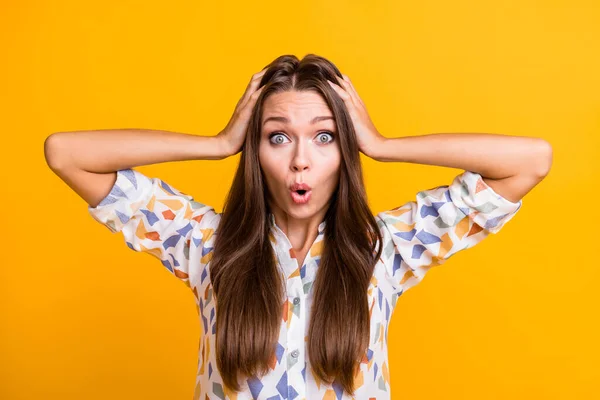 Photo of young girl amazed shocked surprised news information rumor hands touch head isolated over yellow color background — Stockfoto