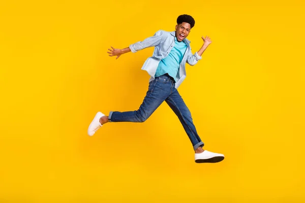 Full length body size view of attractive funny cheerful guy jumping running good mood isolated over bright yellow color background — Fotografia de Stock