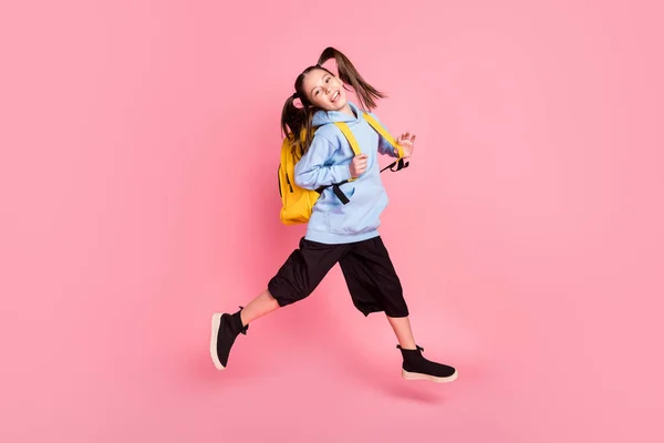 Full length body size photo of jumping girl with yellow backpack wearing sport wear isolated pastel pink color background — Zdjęcie stockowe