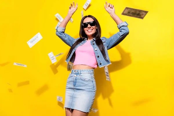 Photo of charming nice pretty young woman rain money fall rich wear cool sunglass smile isolated on yellow color background — Foto Stock