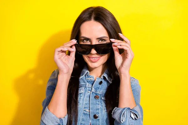 Photo of charming young woman hold hands cool sunglass good mood isolated on yellow color background — Fotografia de Stock