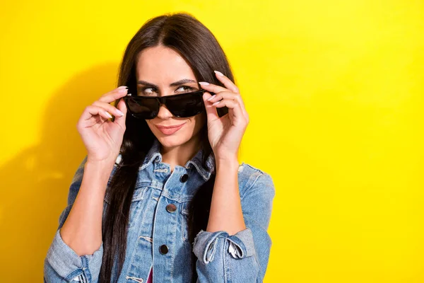 Portrait of attractive cunning girl touching specs looking aside copy space isolated over bright yellow color background — Foto Stock