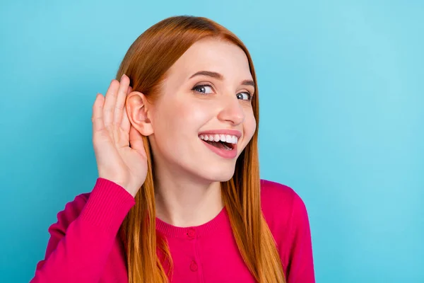 Photo of shiny curious young woman wear pink shirt arm ear listening secrets smiling isolated blue color background — Fotografia de Stock