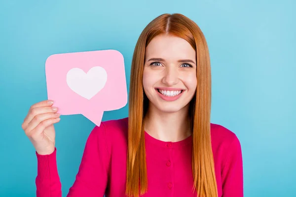 Photo of curious sweet young woman wear pink shirt holding heart like sign smiling isolated blue color background — Fotografia de Stock