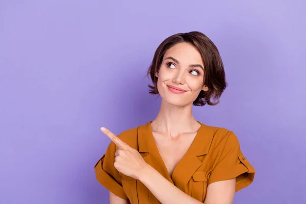 Photo of young woman happy positive smile look indicate finger empty space recommend sale isolated over violet color background — Fotografia de Stock