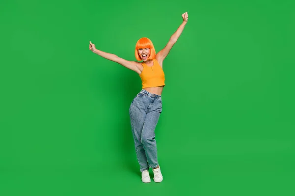 Full length photo of happy nice young woman raise hands winner celebrate isolated on green color background — Fotografia de Stock