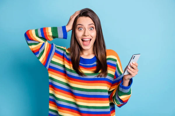 Photo portrait of girl amazed keeping cellphone subscribing touching head isolated on vivid blue color background — стоковое фото