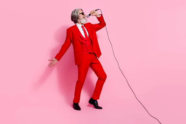 Ganzkörpergröße Ansicht von attraktiven talentierten fröhlichen grauhaarigen Mann singen Hit Spaß isoliert über rosa Pastellfarbe Hintergrund — Stockfoto