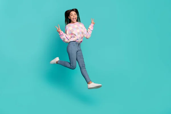 Full length body size view of charming cheery girl jumping showing v-sign isolated over bright teal turquoise color background — Fotografia de Stock