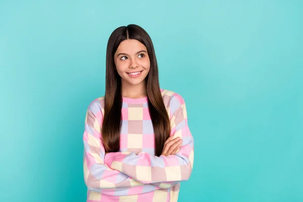 Photo of pretty cute school girl dressed prink pullover arms crossed looking empty space isolated teal color background — Stockfoto