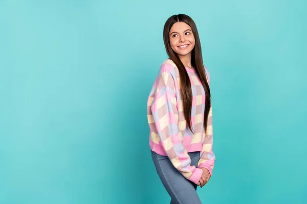 Photo of sweet shiny school girl dressed prink pullover looking back empty space isolated teal color background — Stockfoto