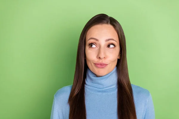 Photo of curious dreamy inspired pretty lady look empty space wear blue turtleneck isolated green color background — Foto Stock
