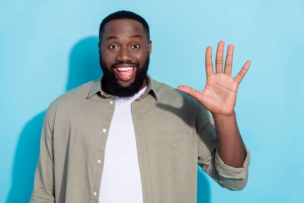 Photo of young excited african man meet his best friend wave hello isolated over blue color background — Stock fotografie